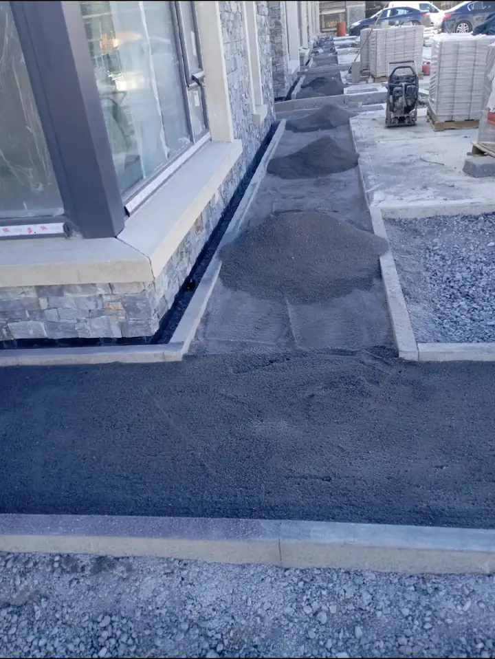 Kerb edge and paving in progress on a development